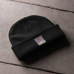 Black fisherman beanie laying on a deck