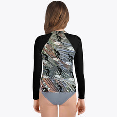 Young surfer sporting a Surfer's Paradise rash guard with a black and white motif