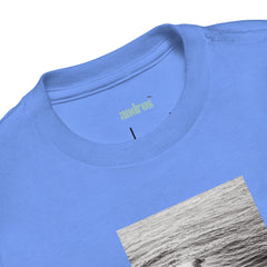 Product detail image showing surf graphic on the front of a toddler t-shirt in heather columbia blue